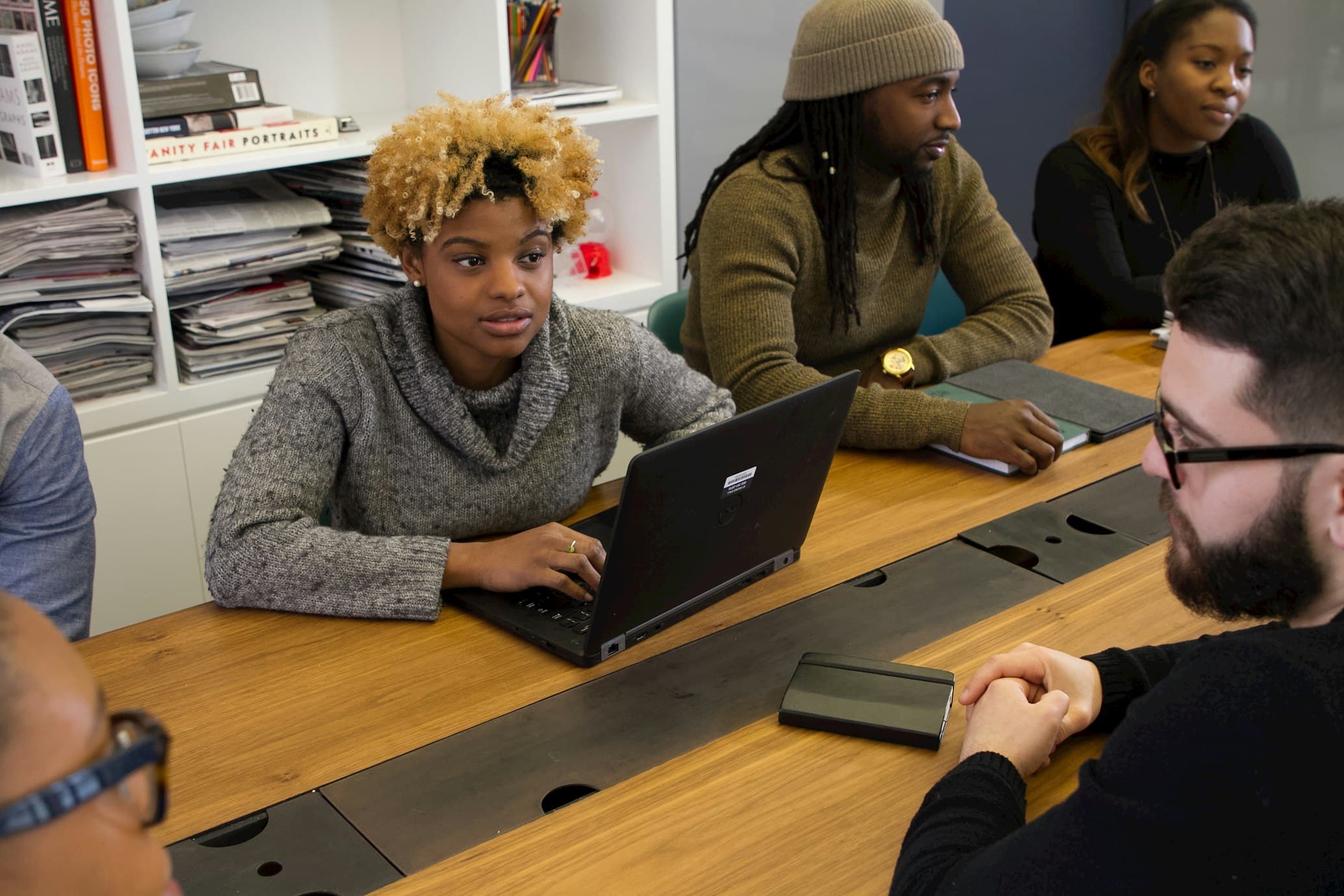 Diverse tech students collaborating in a modern workspace